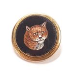 Micro mosaic brooch of a cat in a gilt framed yellow surround.