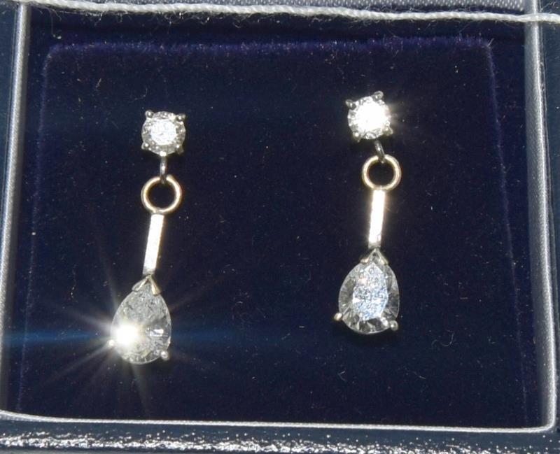 A pair of 18ct white gold and diamond drop earrings with Brilliant cut and pear shaped drop.