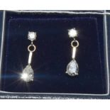 A pair of 18ct white gold and diamond drop earrings with Brilliant cut and pear shaped drop.