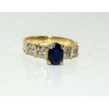 A 14ct gold ladies sapphire and diamond ring, Size K.