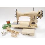 A vintage Liberty Sewing machine with original Accessory tin to include Sewing Machine oil can and