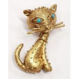 18 carat gold brooch depicting a cat with turquoise set eyes.