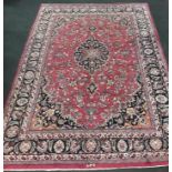 Handmade woollen Mashad carpet, central medallion in blue link with red floral, guard repeated