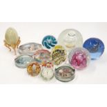A collection of glass paperweights to include Caithness millefori and imperial.