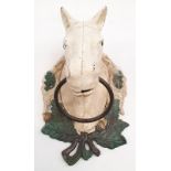 A cast iron towel rail in the form of a horse head.