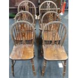 Set of six wheel back oak dining chairs to include carvers.