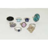 Collection of 9 silver rings with semi precious stones.