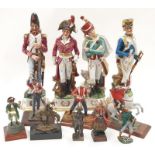 Four porcelain military guard figures together with a collection of other figurines.