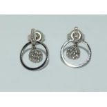 A pair of white gold and diamond 18ct earrings.