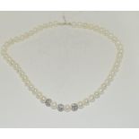 A fresh water pearl necklace with CZ ball spacers.