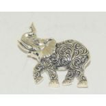 A silver elephant brooch.