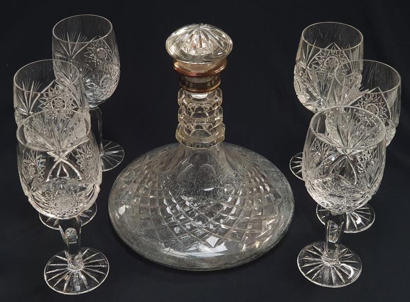 A crystal glass ships decanter with silver rim together with a set of six crystal glasses.