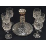 A crystal glass ships decanter with silver rim together with a set of six crystal glasses.