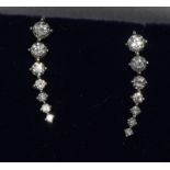 A pair of 18ct white gold graduated diamond earrings.