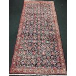 Handmade woollen Hamadan carpet with central repeated floral design in blue and cream Palmette guard