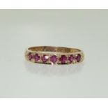 A 9ct gold ladies Ruby and Diamond 1/2 eternity ring.