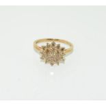 A Champagne diamond cluster 9ct gold ring.