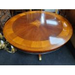 Mahogany inlaid coffee table on brass castors with bird cage pillar support.