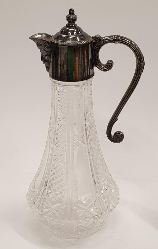 Cut glass silver plated claret jug with a lion's head pourer.