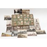 A vintage cigarette card album together with a small collection of vintage postcards.