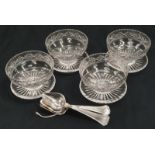 4 glass grapefruit dishes and a set of grapefruit spoons.