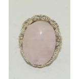 A silver and large rose Quartz ring. Size R