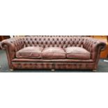 Three seater leather Chesterfield settee with Chesterfield badge.