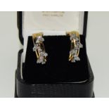 A pair of 18ct gold diamond earrings approx 1.00total.
