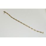 18ct gold and diamond line bracelet. 18.5cms. 11.9 grams.