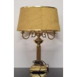 A brass column table lamp with shade together with a small marble table lamp (no shade).