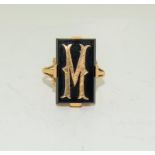 An 18ct yellow gold tested 19th century ring set with onyx and gold M symbol, Size Q.