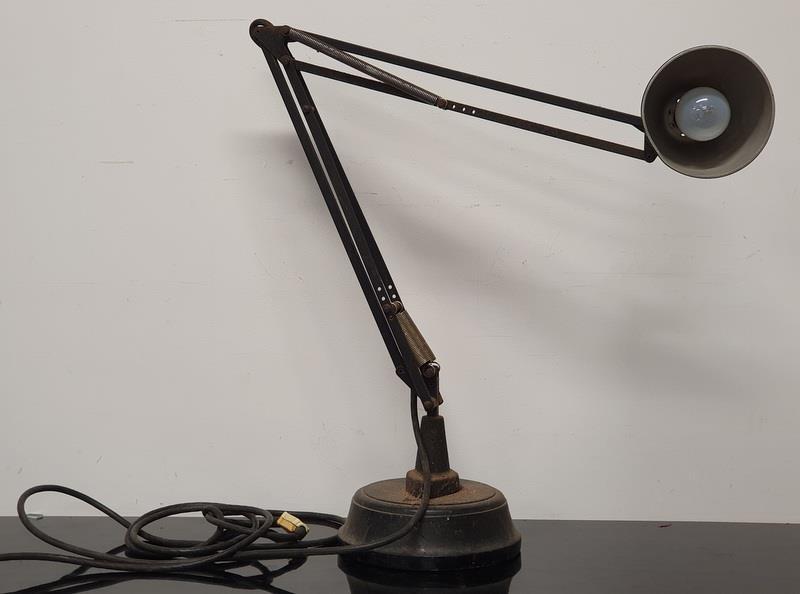 An antique industrial Anglepoise style lamp with solid base.