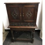 Charles II and later oak cupboard on the stand.