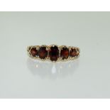 A 9ct gold antique set five stone garnet ring, Size R.