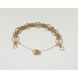 A 9ct gold fancy link bracelet with heart clasp.