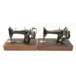 Pair of vintage Singer sewing machines.