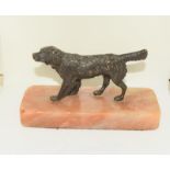 Bronze figure of a retriever dog.