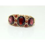 9 carat gold ladies antique set garnet ring, Size M.