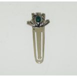 A silver bookmark with frog finial.