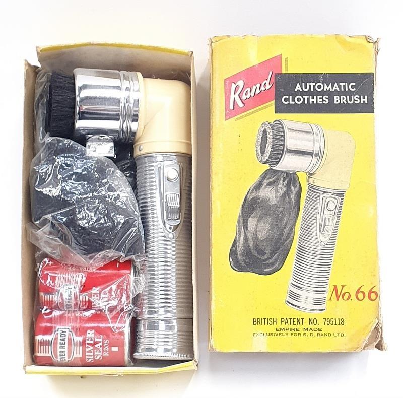 A 1950s Bakelite hand-held battery operated clothes brush boxed.
