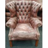 Wing back leather Chesterfield armchair with Chesterfield badge.
