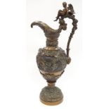 A large bronze wine ewer depicting cherubs decorated to all sides 55 cm tall.