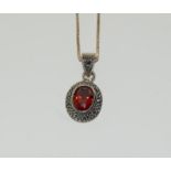 A silver Marcasite and Garnet pendant necklace on silver chain.