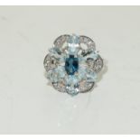 A silver and CZ and Aquamarine cluster ring. Size N.