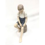 Danish B&G (Bing & Grondahl) figurine number 1757 - boy rolling up his trousers.