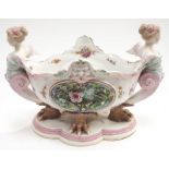 A porcelain Dresden style table centrepiece with claw feet flanked on either side by two ladies.
