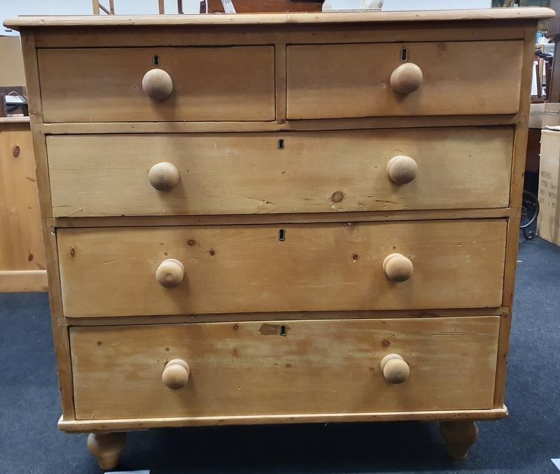 Victorian two over three pine chest of drawers on tapered feet.