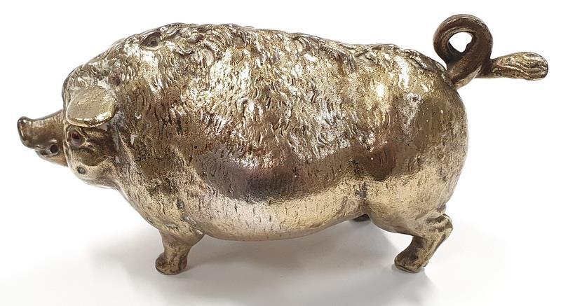 A vintage solid brass wind up bell in the form of a pig.