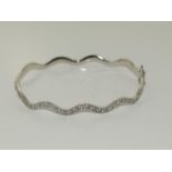 9ct white gold wavey CZ bangle. 7g.