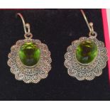 A pair of silver and peridot Art Deco style earrings.